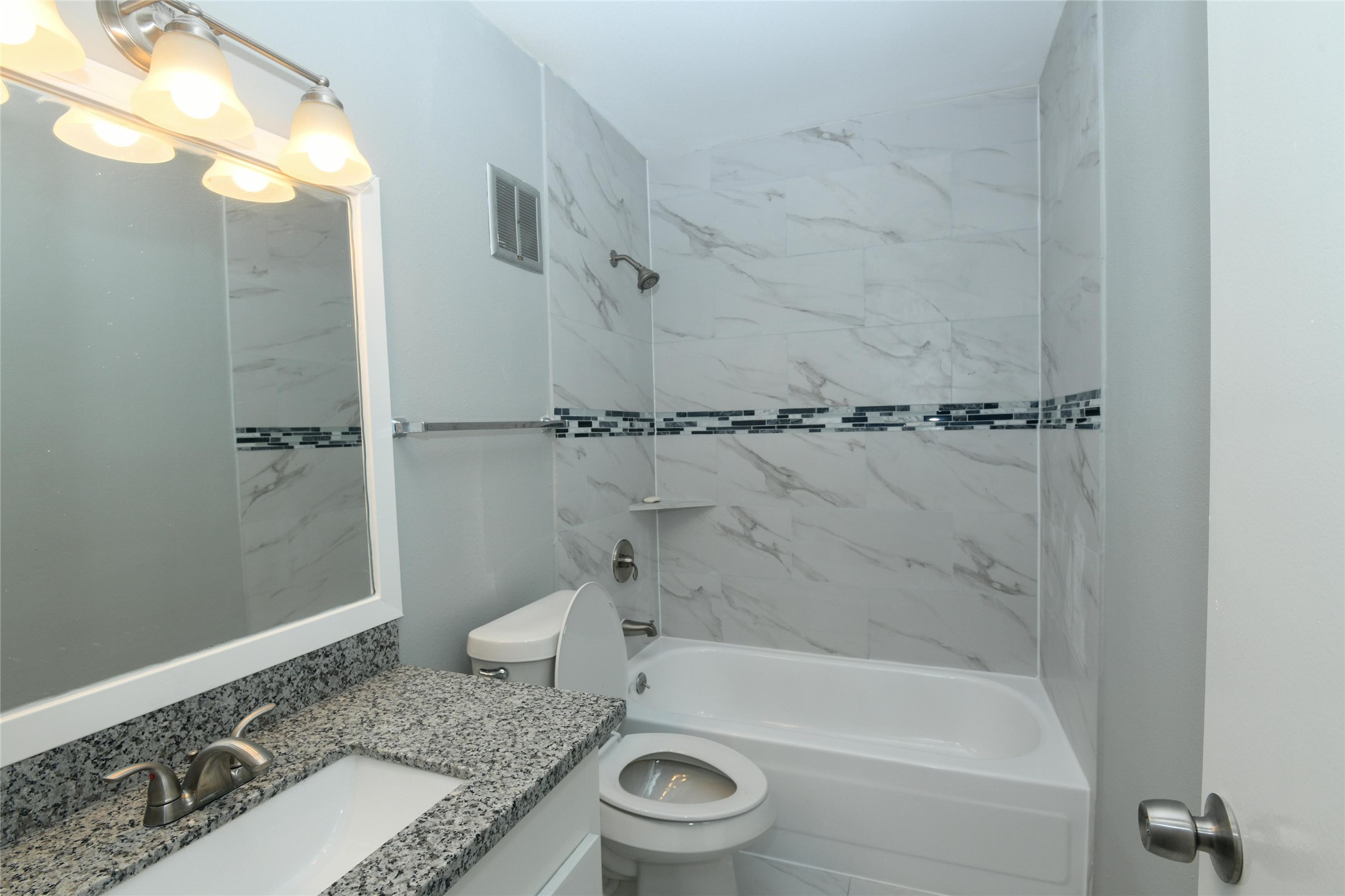 2675 Gessner Road, Unit 103 Houston, TX 77080 - Photo 10 of 13 a bathroom with a granite countertop bathtub shower sink and toilet