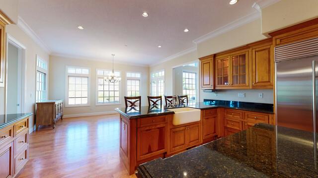 9560 Vía Del Oro Gilroy, CA 95020 - Photo 12 of 65 a large kitchen with kitchen island granite countertop a stove a sink a refrigerator dining table and chairs