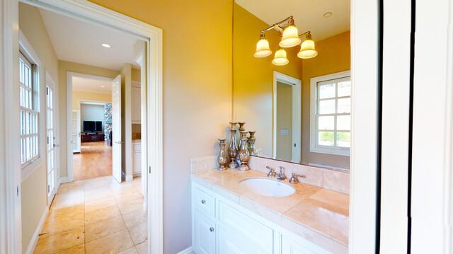 9560 Vía Del Oro Gilroy, CA 95020 - Photo 49 of 65 a en suite bathroom with a granite countertop sink and a mirror