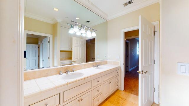 9560 Vía Del Oro Gilroy, CA 95020 - Photo 63 of 65 a bathroom with a double vanity sink and a mirror
