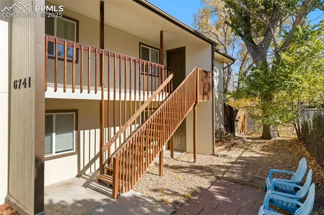 a view of balcony with wooden floor and fence