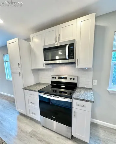 a view of a kitchen with a sink and a stove top oven