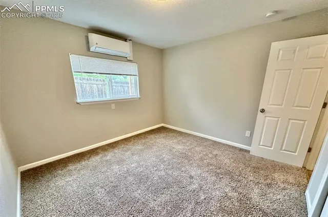 an empty room with windows and closet