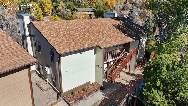 a view of a wooden deck front of house