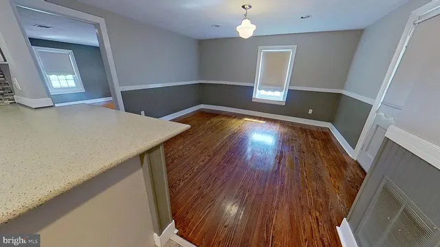 a view of room with wooden floor