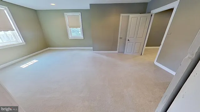 a bathroom with a granite countertop toilet sink and mirror