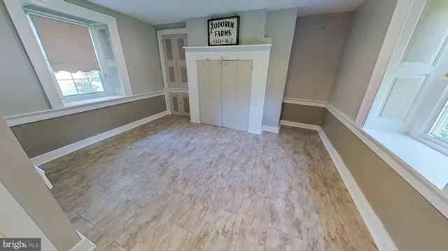 wooden floor in an empty room with a window