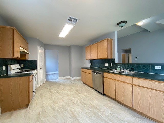 1512 Lorson Loop Round Rock, TX 78665 - Photo 16 of 29 a large kitchen with stainless steel appliances granite countertop a stove a sink dishwasher and a microwave oven on the granite countertops