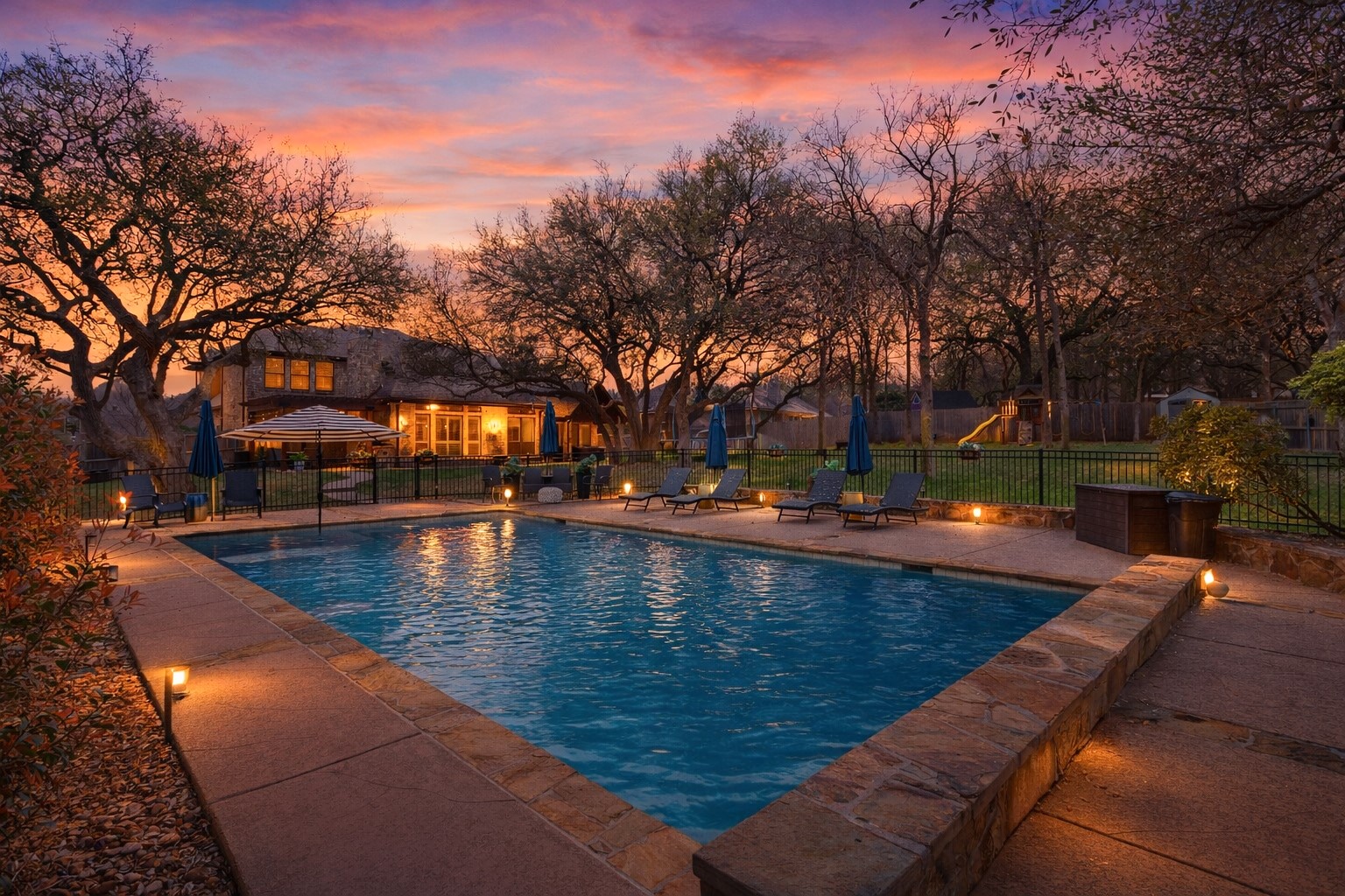 Backyard retreat featuring a private pool surrounded by mature trees on an estate sized lot.