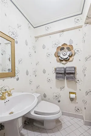 a bathroom with a sink a toilet and shower curtain