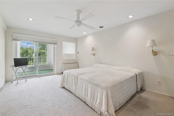 a spacious bedroom with a bed and a table