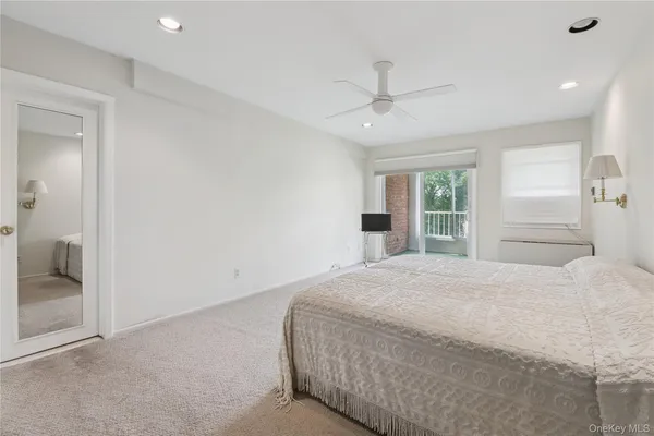 a bedroom with a large bed closet and window