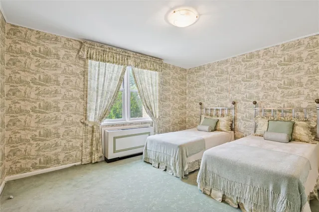 a bedroom with two beds and a window