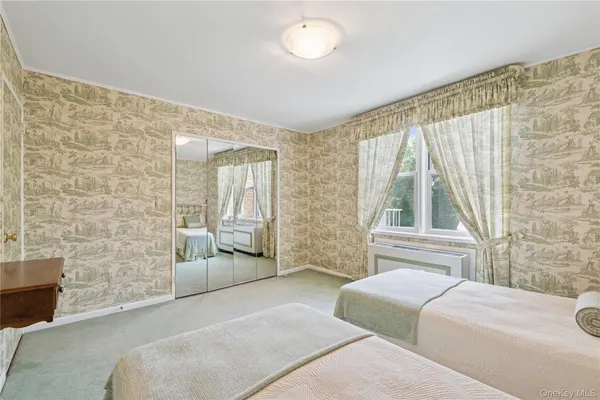 a spacious bedroom with a bed and a couch