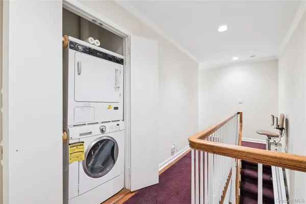 a view of a hallway with washer and dryer
