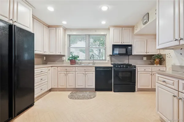 a kitchen with a sink stove and refrigerator
