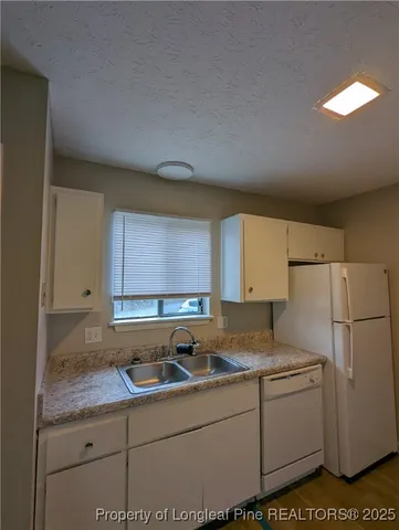 a kitchen with a stove and a white cabinets