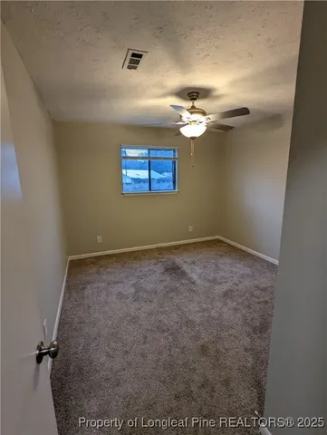 an empty room with a empty space and a ceiling fan