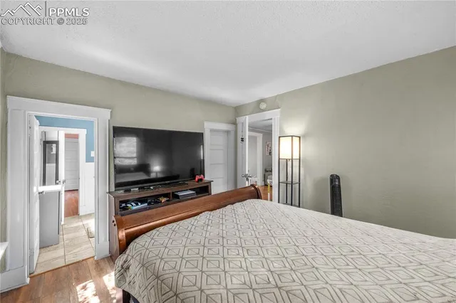 a bedroom with a bed and a flat screen tv