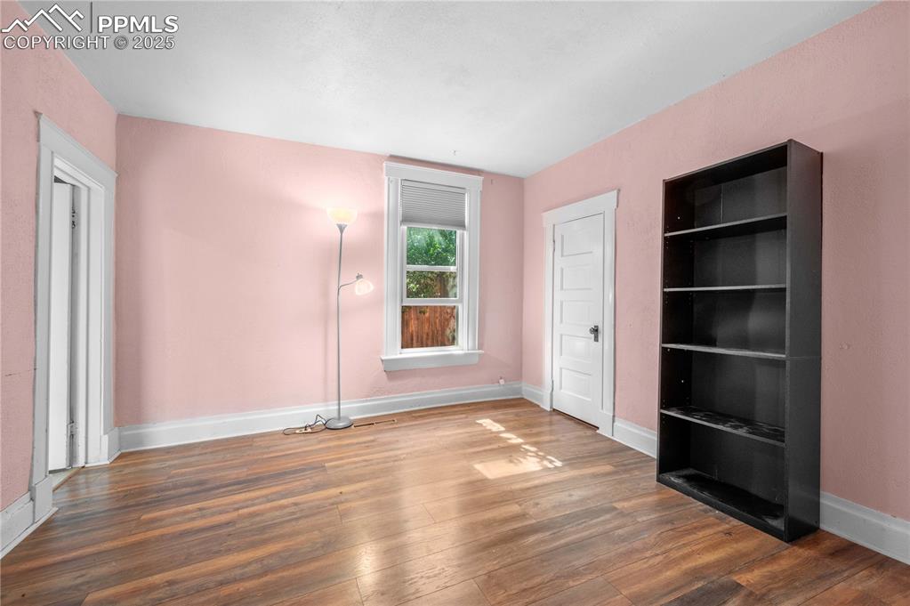 609 Rudd Avenue Canon City, CO 81212 - Photo 13 of 20 a view of an empty room with wooden floor and a window
