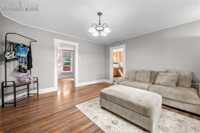 a living room with furniture and a chandelier