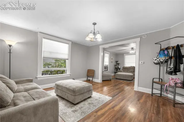 a living room with furniture and a chandelier