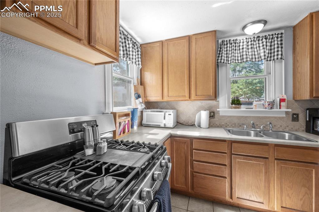 609 Rudd Avenue Canon City, CO 81212 - Photo 9 of 20 a kitchen with a stove a sink and a window