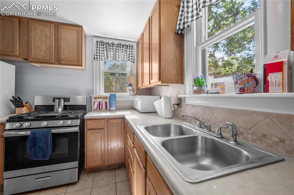 609 Rudd Avenue Canon City, CO 81212 - Photo 10 of 20 a kitchen with a stove sink and glass door