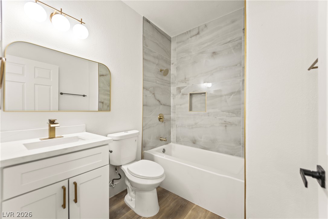 4730 East Craig Road, Unit 1053 Las Vegas, NV 89115 - Photo 9 of 32 A well-appointed bathroom with a modern vanity, elegant tile-surround tub, and golden fixtures.