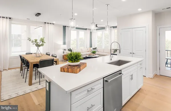 a kitchen with sink and refrigerator