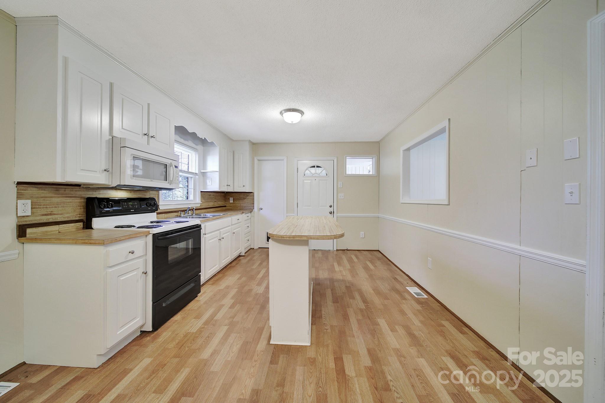 157 Holiday Road Lancaster, SC 29720 - Photo 11 of 31 a kitchen with granite countertop a stove top oven a sink dishwasher and a refrigerator with wooden floor