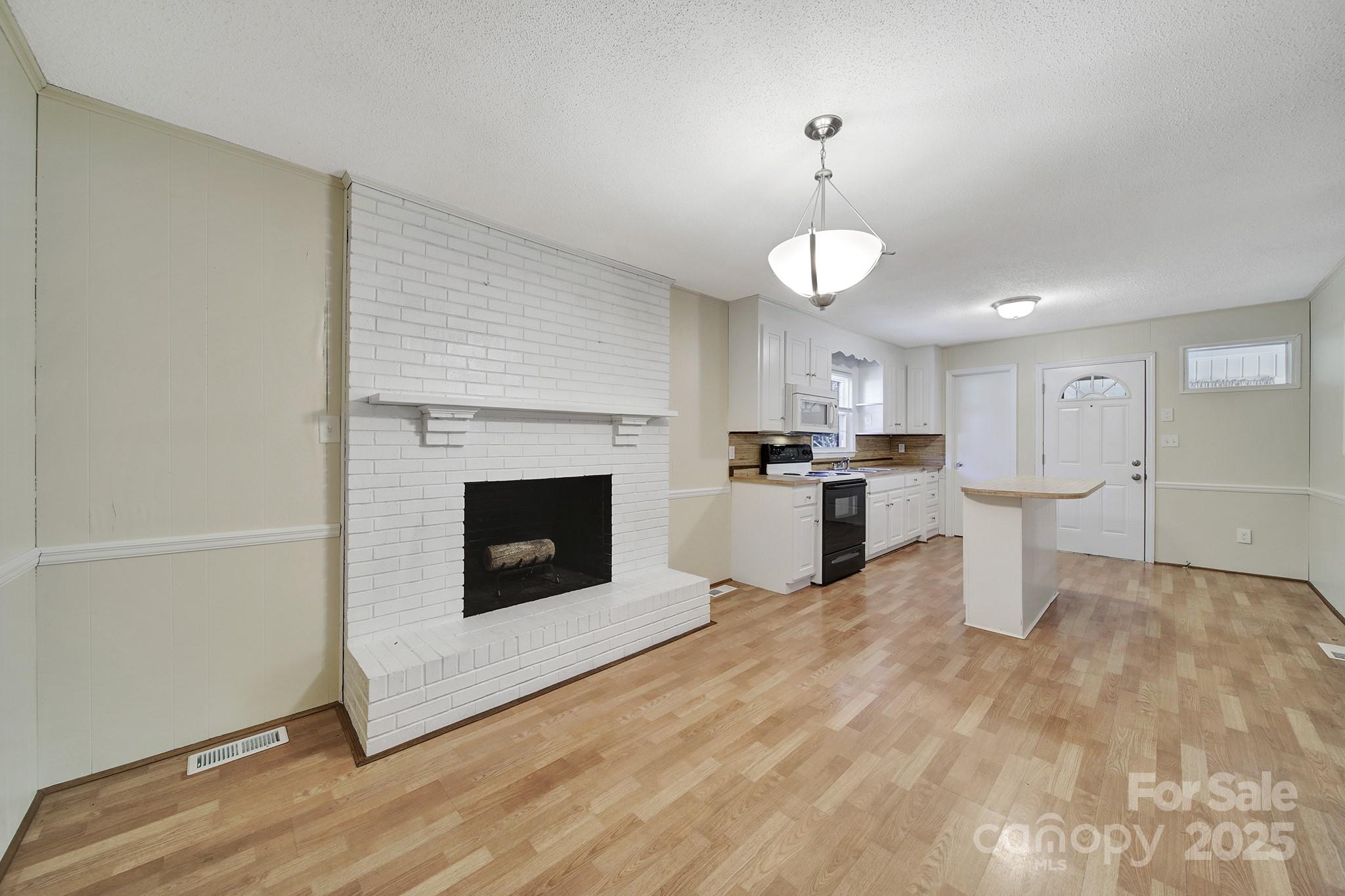 157 Holiday Road Lancaster, SC 29720 - Photo 14 of 31 a view of a kitchen with a sink and a fireplace