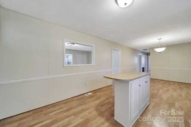 a kitchen with a sink cabinets and wooden floor