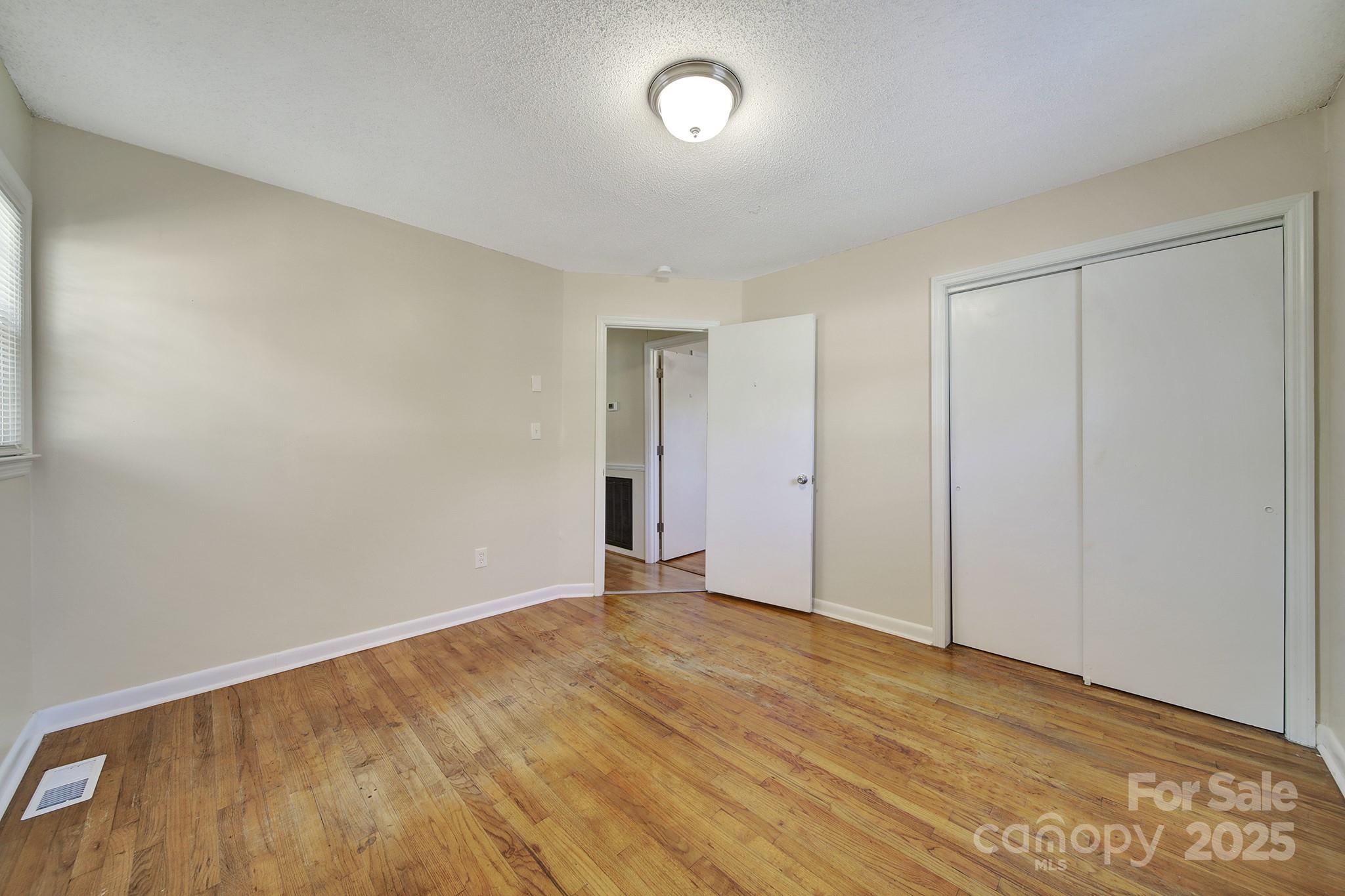 157 Holiday Road Lancaster, SC 29720 - Photo 19 of 31 a view of an empty room with wooden floor and a window