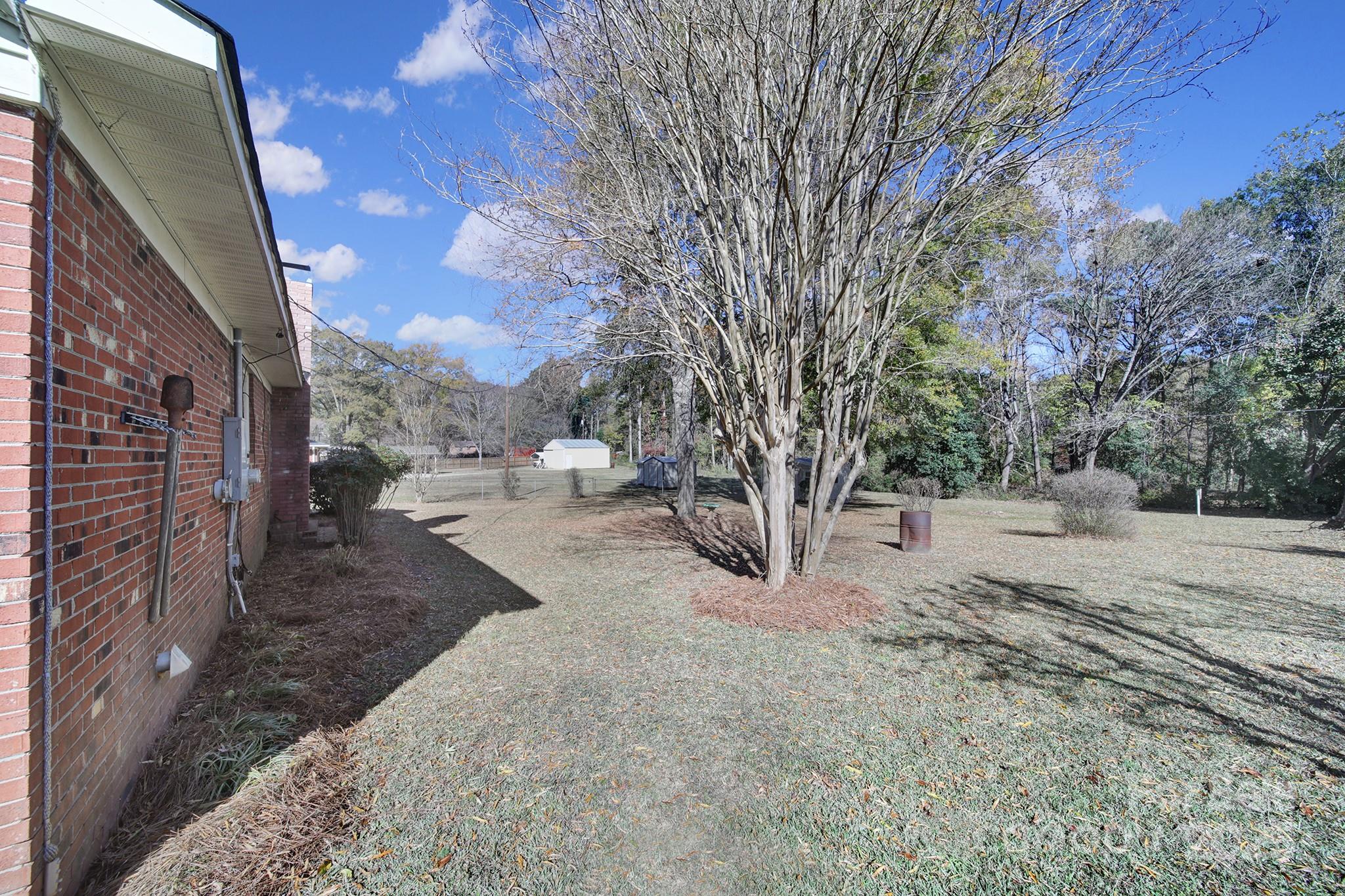 157 Holiday Road Lancaster, SC 29720 - Photo 27 of 31 a view of a backyard with large trees