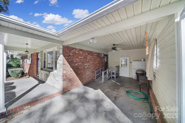 a view of a hallway with a couch and chairs