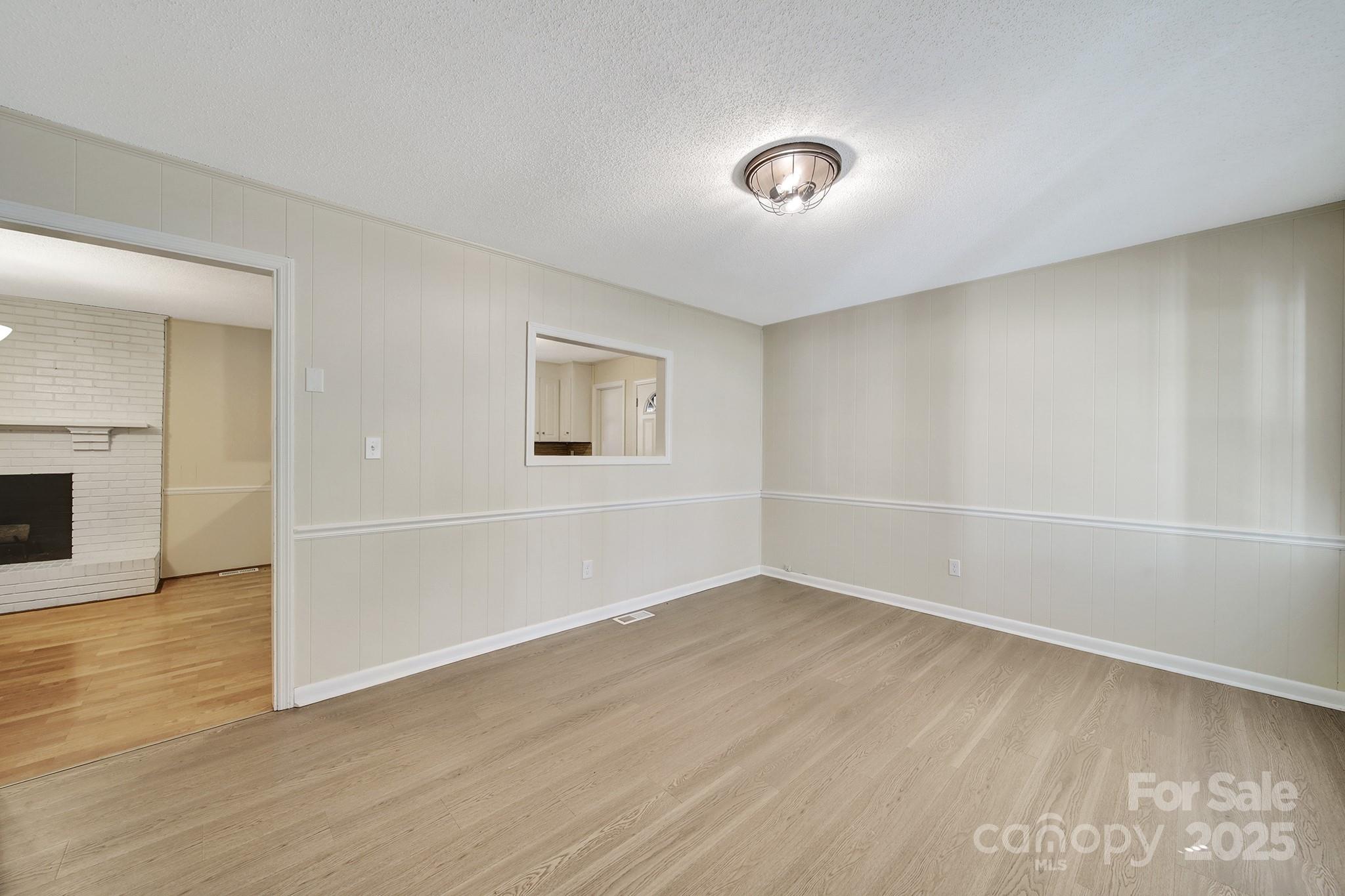 157 Holiday Road Lancaster, SC 29720 - Photo 9 of 31 an empty room with wooden floor and windows