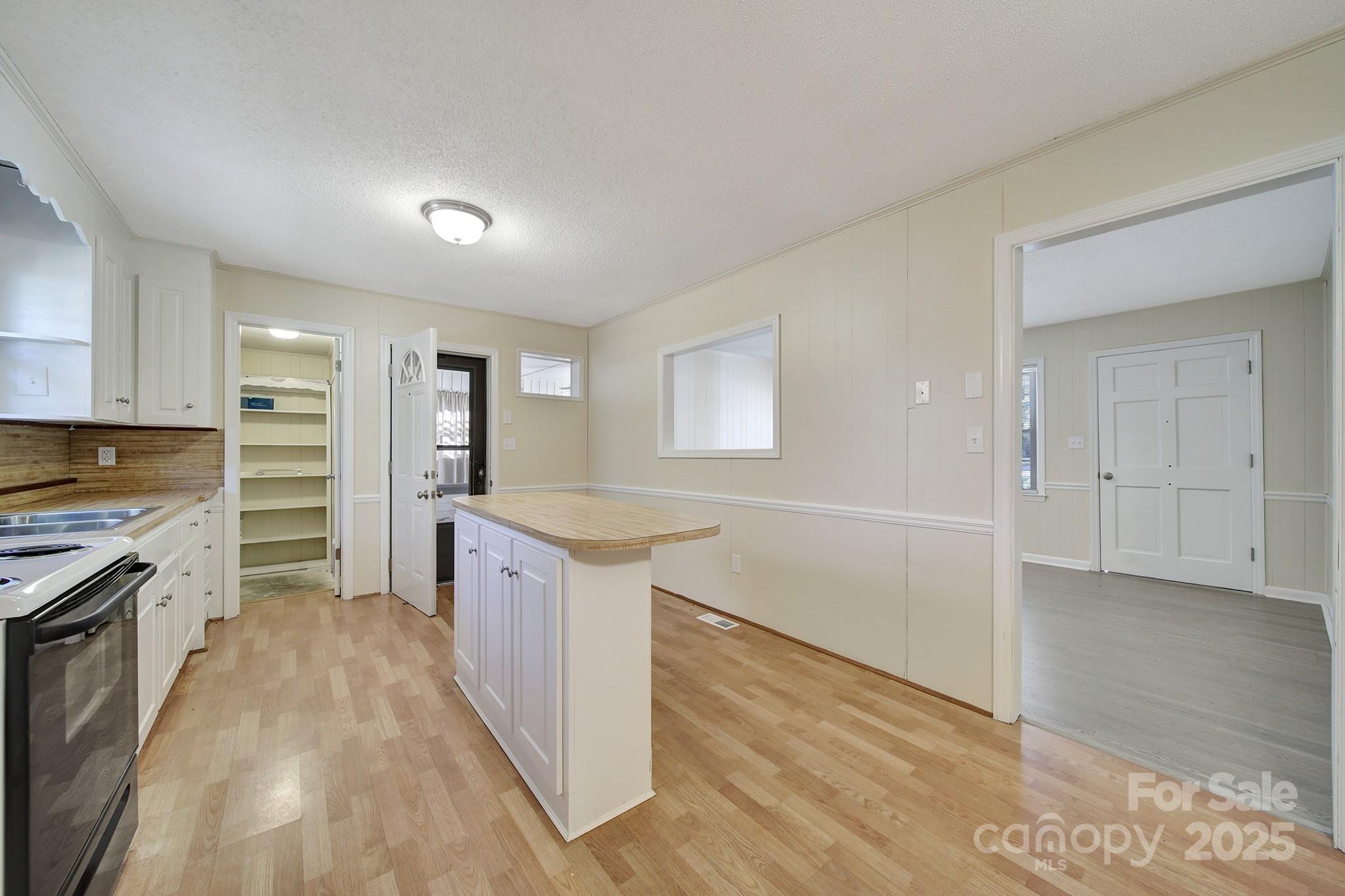 157 Holiday Road Lancaster, SC 29720 - Photo 10 of 31 a large kitchen with cabinets wooden floor and stainless steel appliances