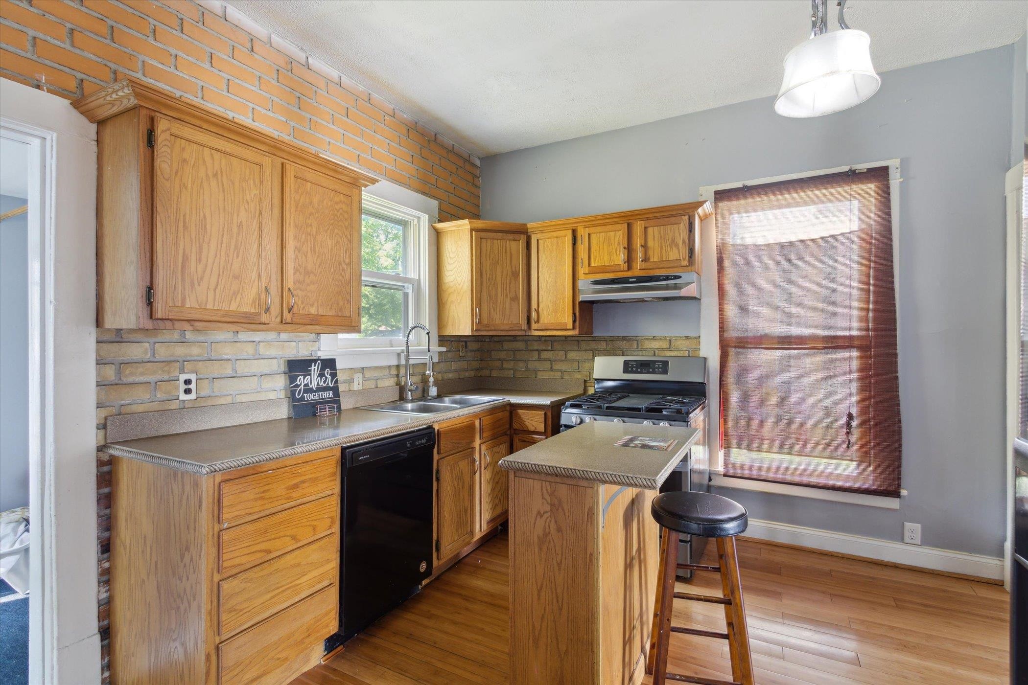 1304 East 4th Street Sterling, IL 61081 - Photo 16 of 30 a kitchen with a window a sink and wooden cabinets