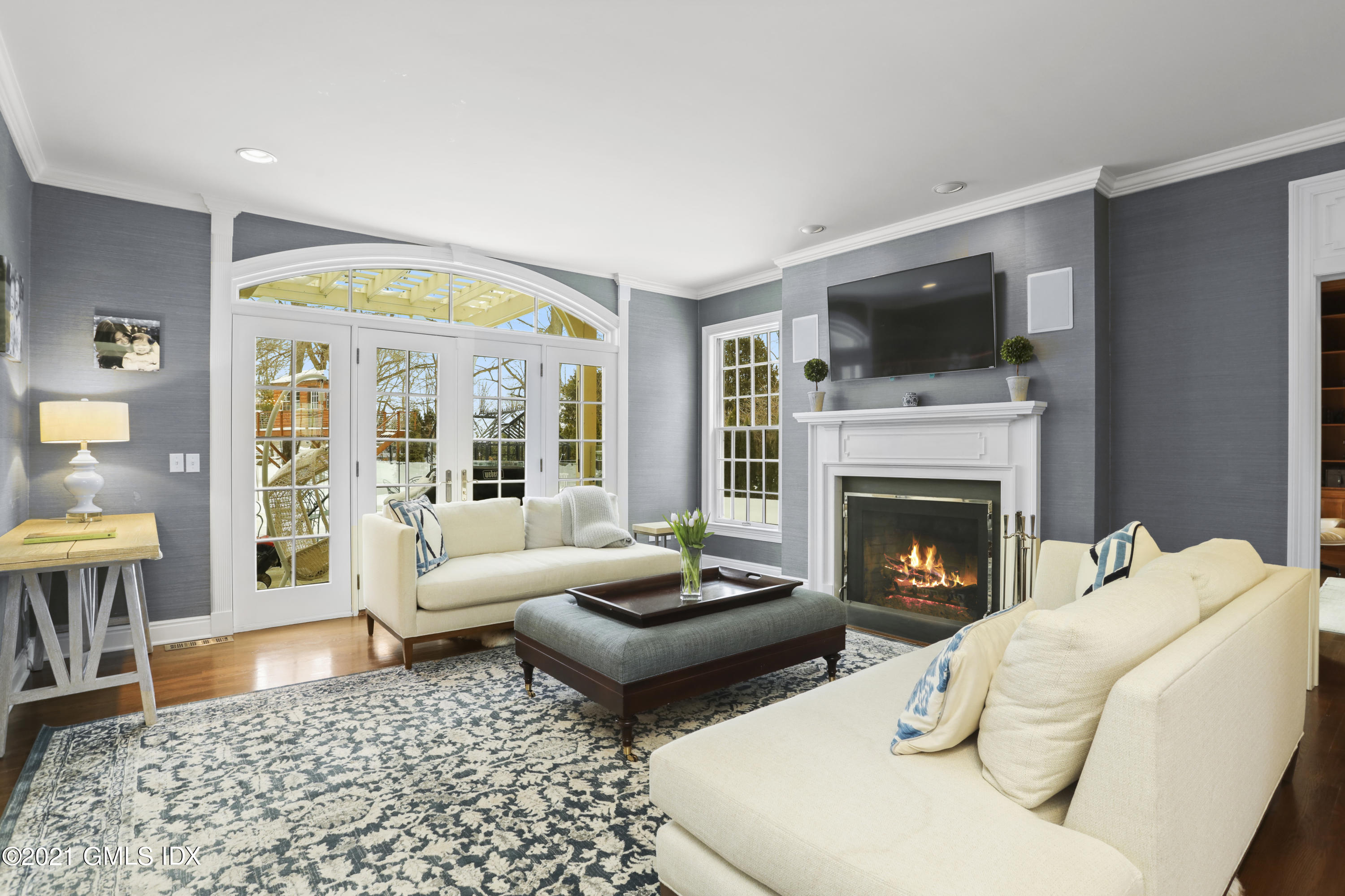 41 Dawn Harbor Lane Riverside, CT 06878 - Photo 12 of 33 a living room with furniture fireplace and a flat screen tv