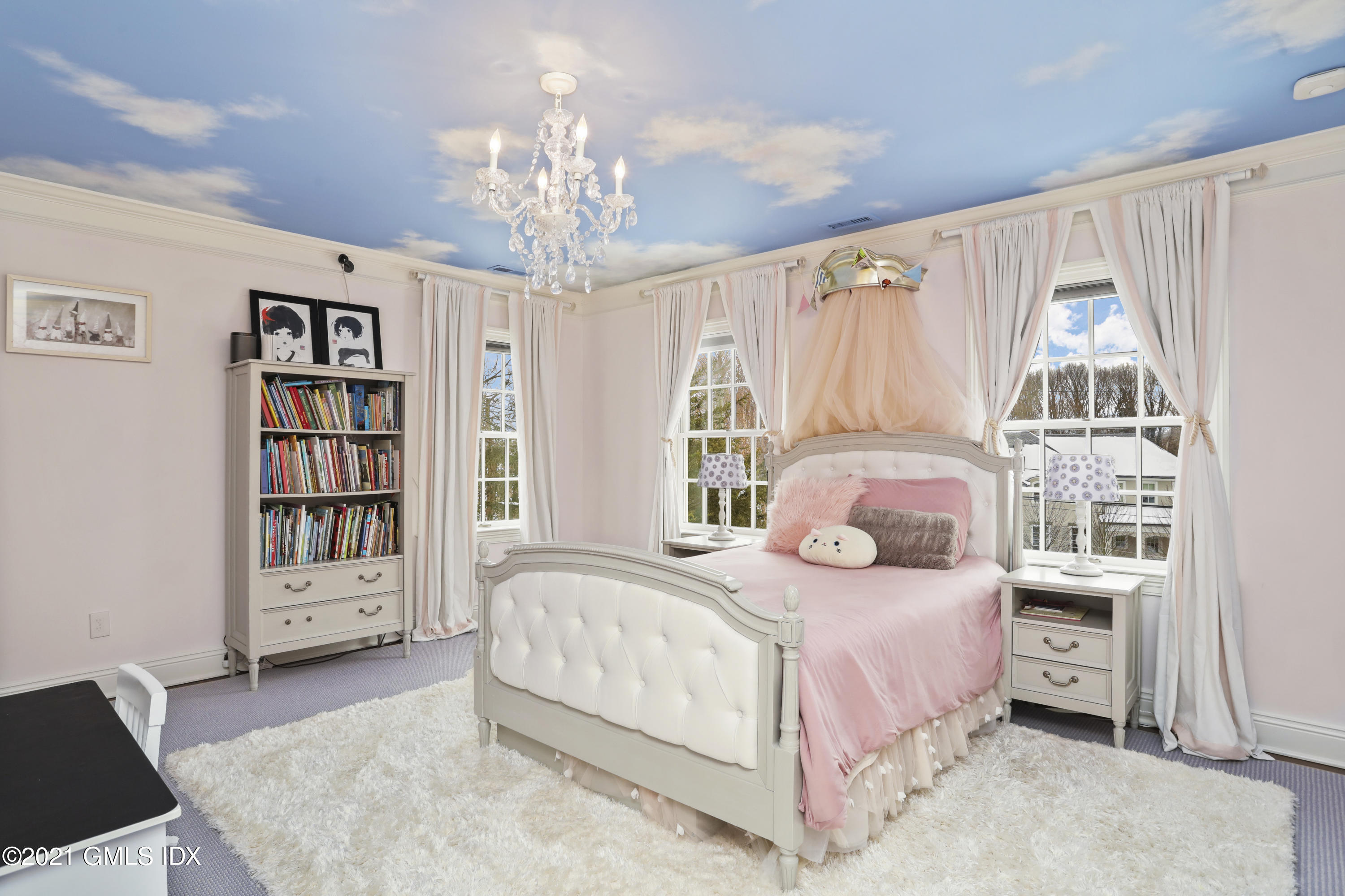 41 Dawn Harbor Lane Riverside, CT 06878 - Photo 18 of 33 a bedroom with a large bed and a chandelier