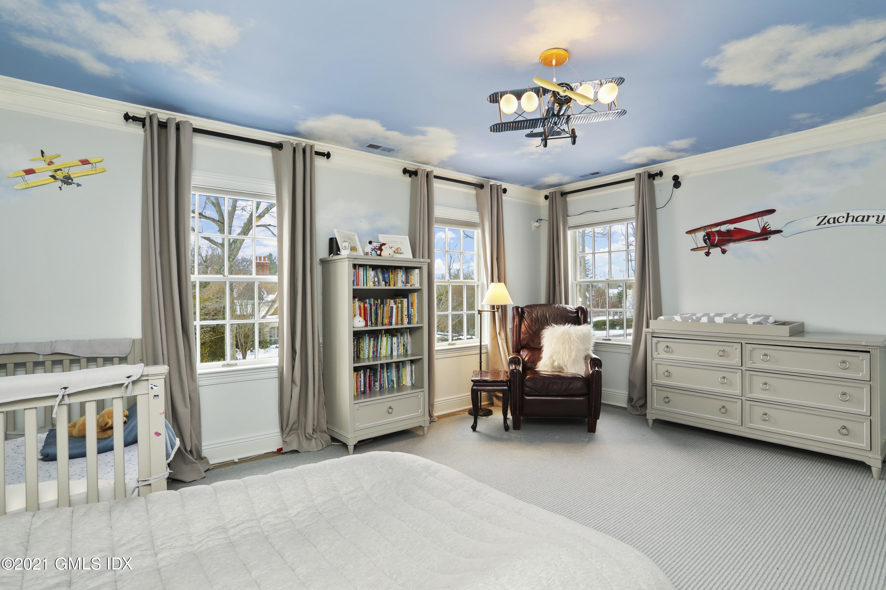 41 Dawn Harbor Lane Riverside, CT 06878 - Photo 19 of 33 a bedroom with furniture and a chandelier