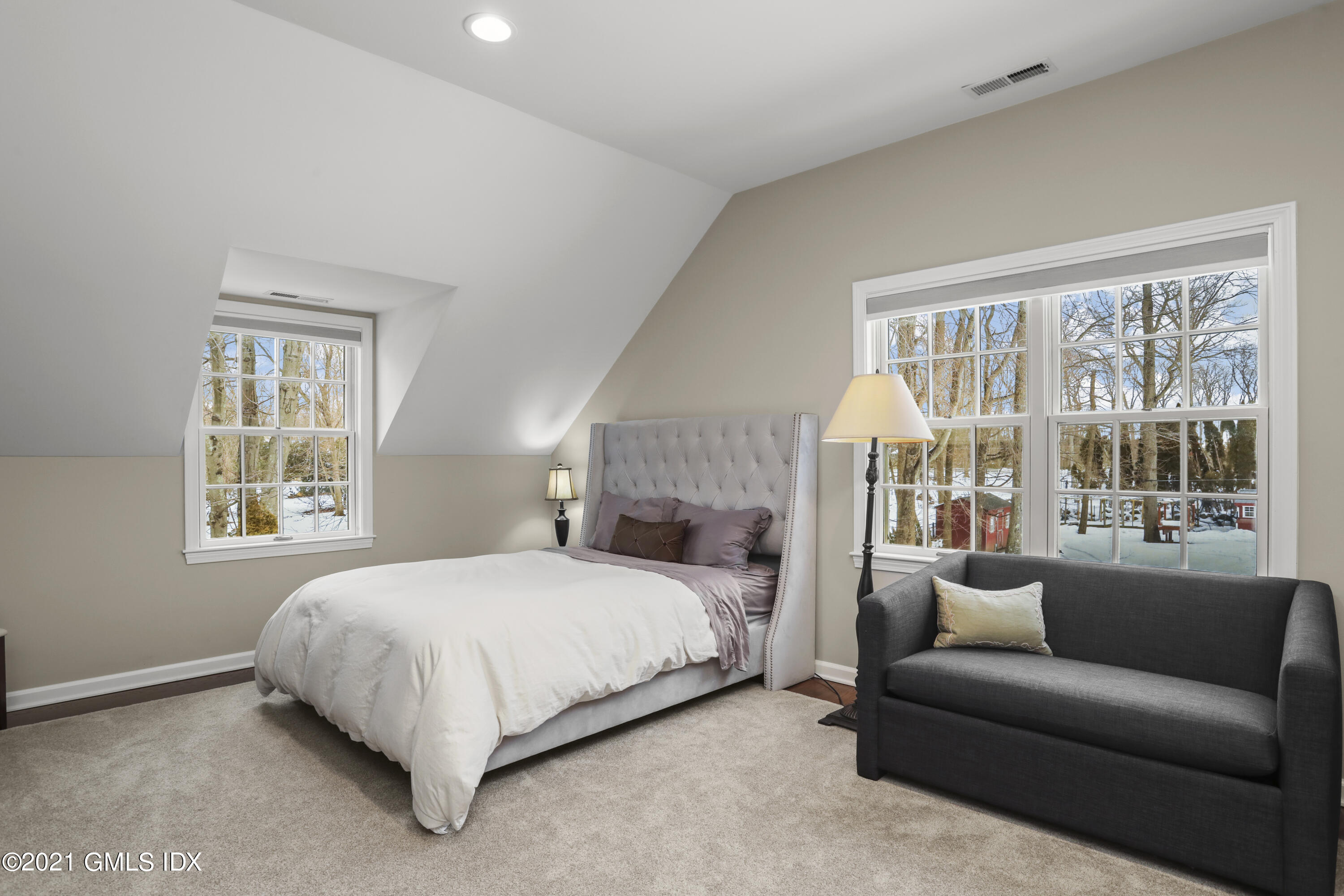 41 Dawn Harbor Lane Riverside, CT 06878 - Photo 22 of 33 a bedroom with a bed couch and a large window