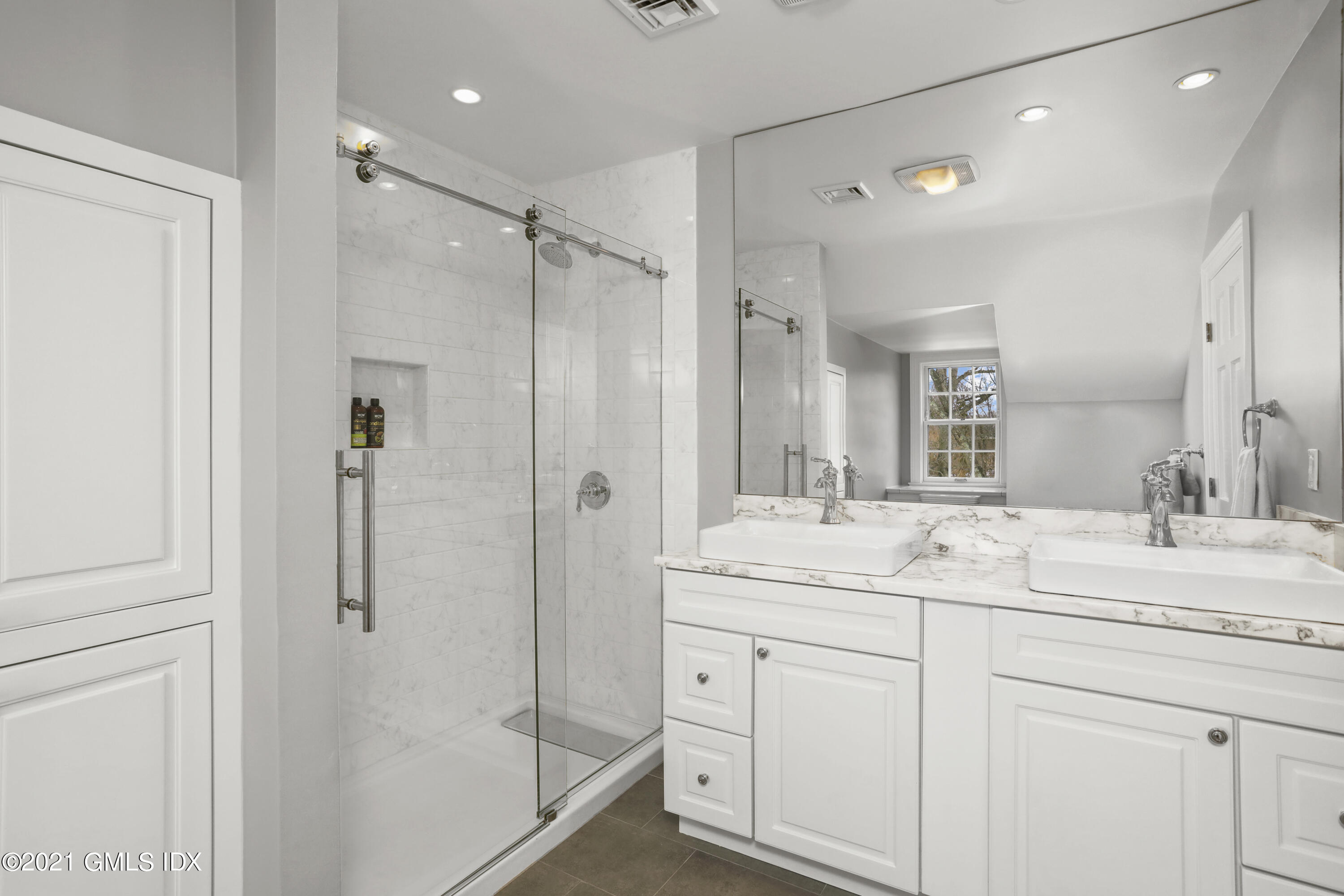 41 Dawn Harbor Lane Riverside, CT 06878 - Photo 24 of 33 a bathroom with a shower sink and mirror