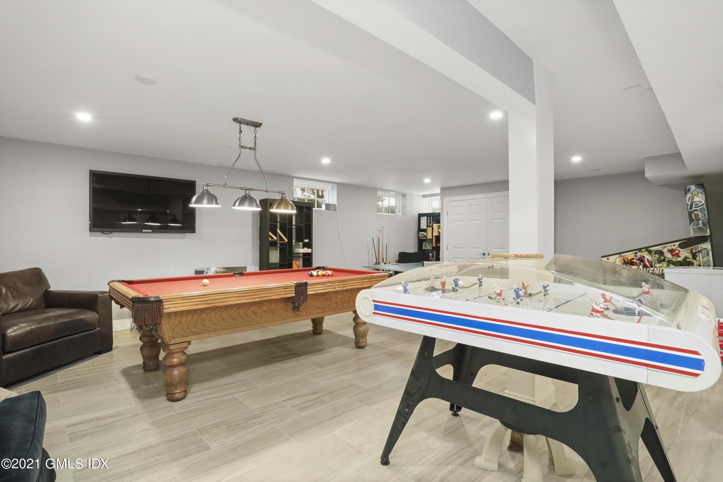 41 Dawn Harbor Lane Riverside, CT 06878 - Photo 29 of 33 a room with a table chairs and flat screen tv