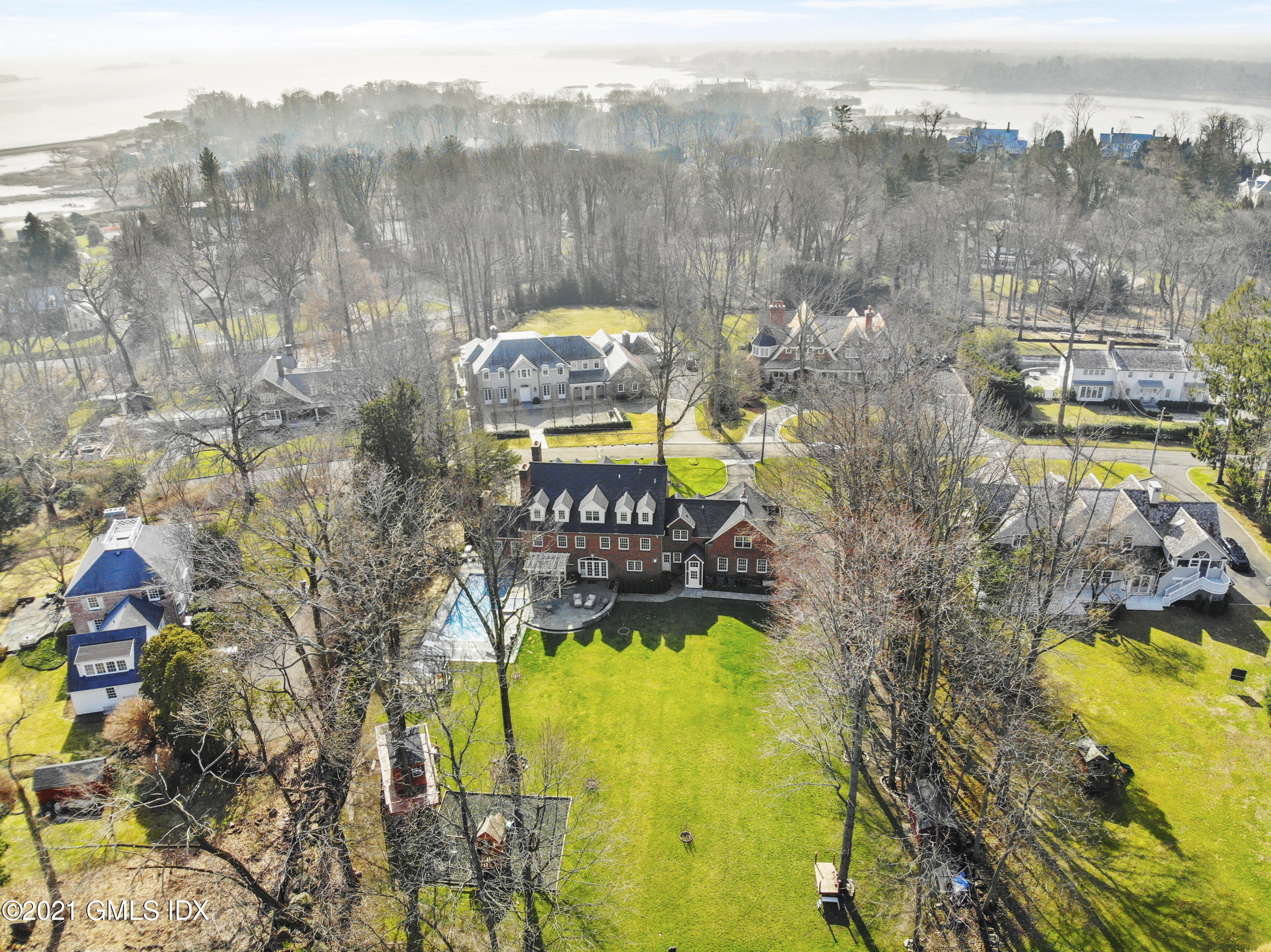 41 Dawn Harbor Lane Riverside, CT 06878 - Photo 32 of 33 a view of a swimming pool with a yard