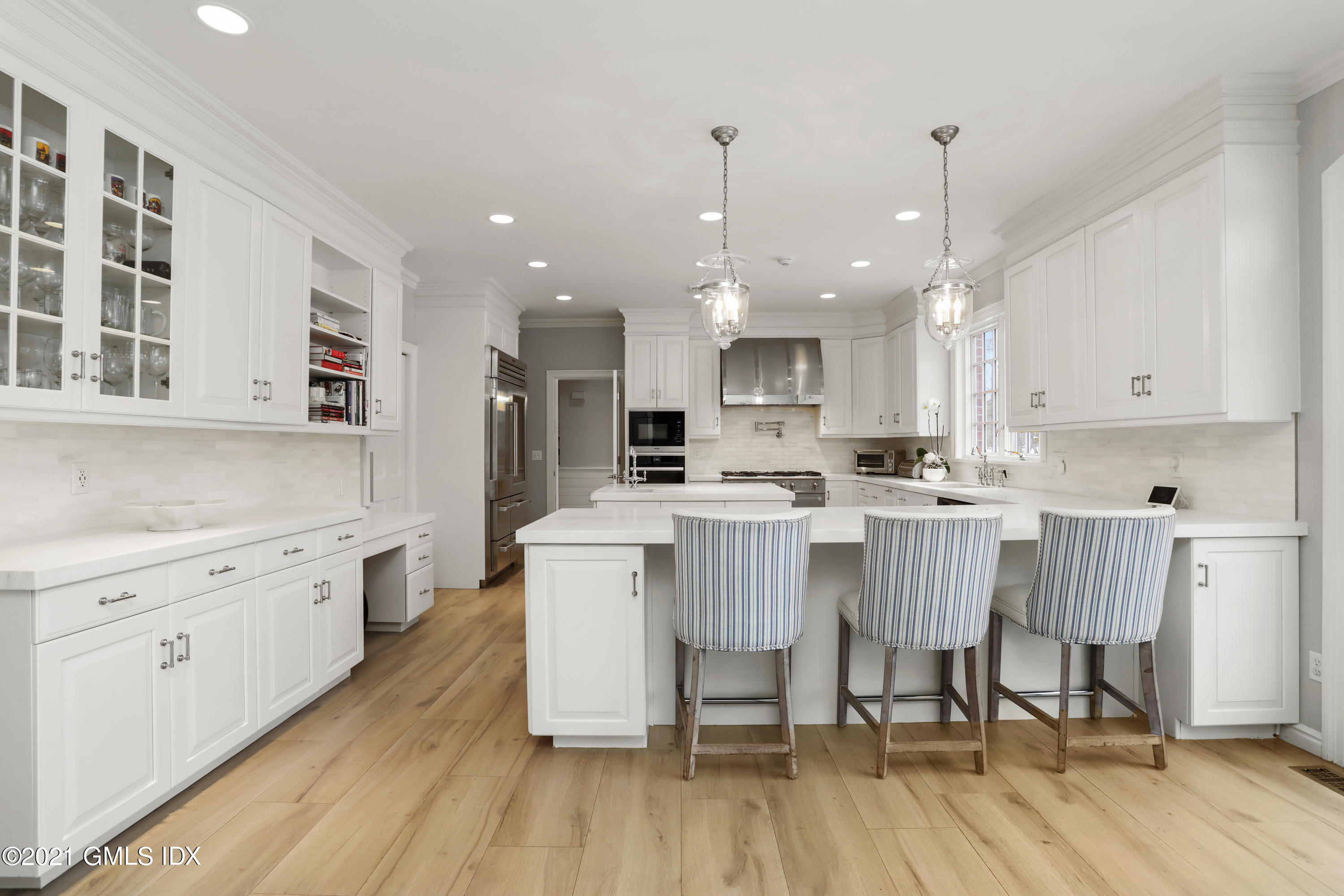 41 Dawn Harbor Lane Riverside, CT 06878 - Photo 4 of 33 a large kitchen with kitchen island a white cabinets and wooden floor