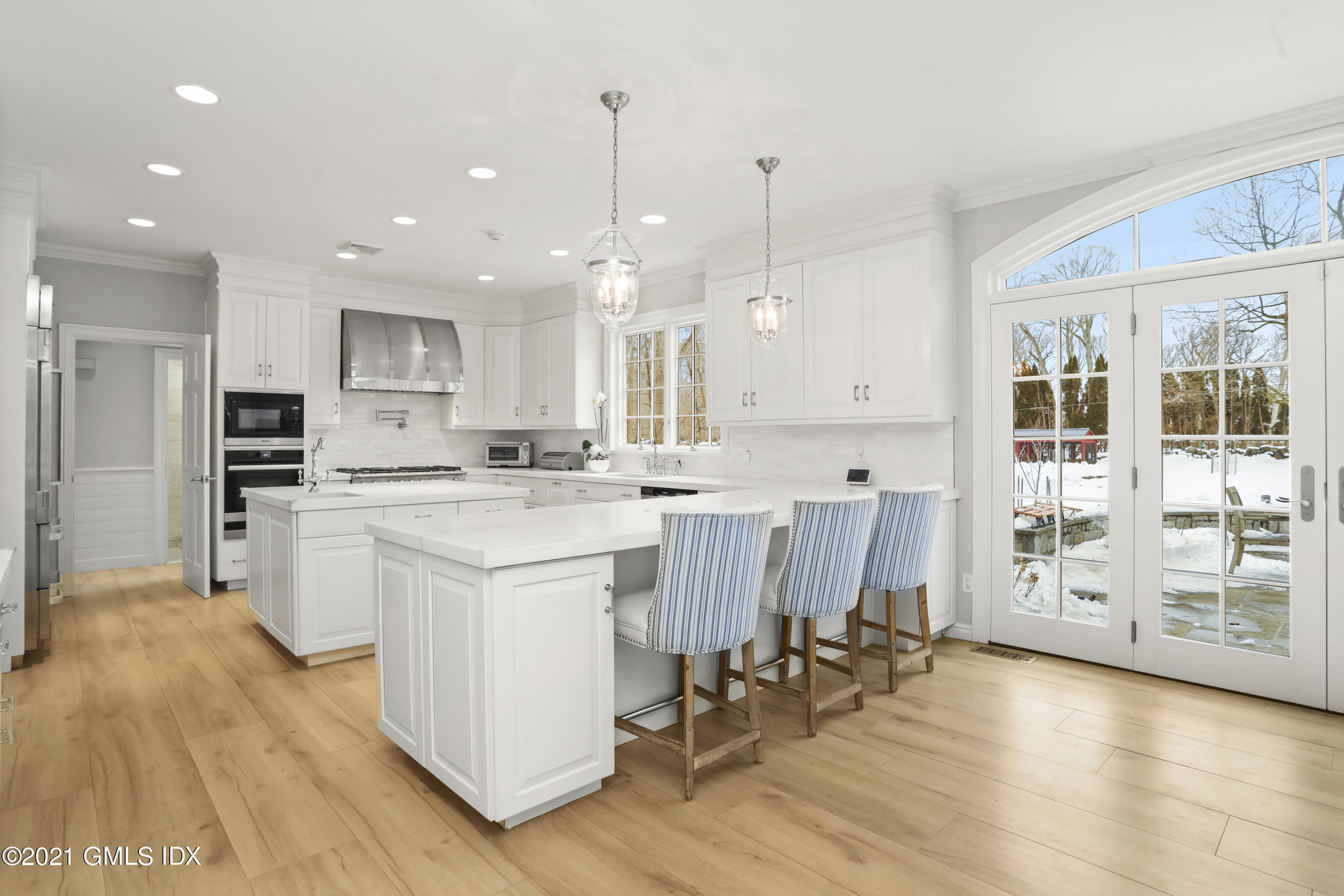 41 Dawn Harbor Lane Riverside, CT 06878 - Photo 5 of 33 a kitchen with white cabinets and stainless steel appliances