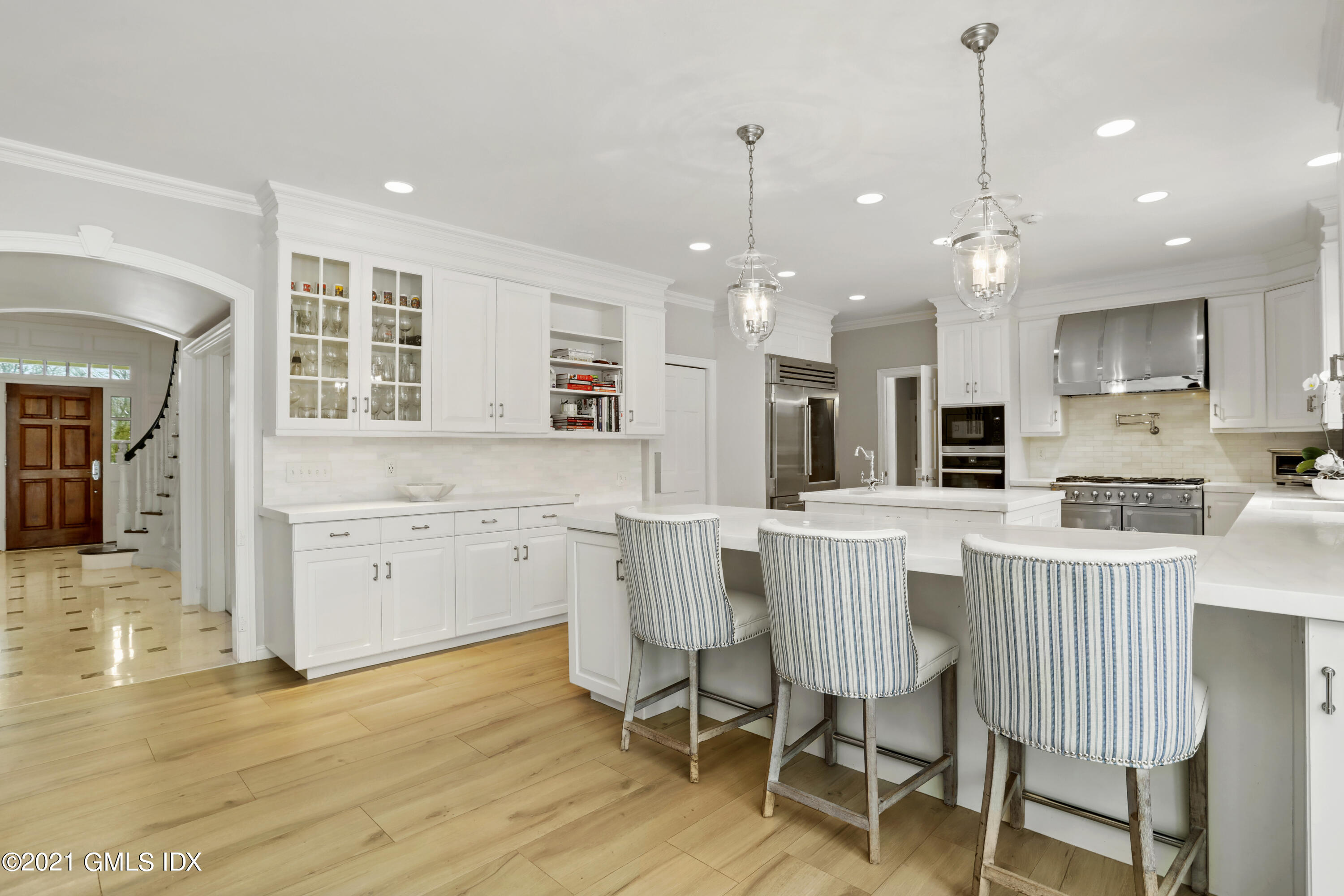 41 Dawn Harbor Lane Riverside, CT 06878 - Photo 6 of 33 a kitchen with stainless steel appliances granite countertop a dining table chairs stove a refrigerator and cabinets