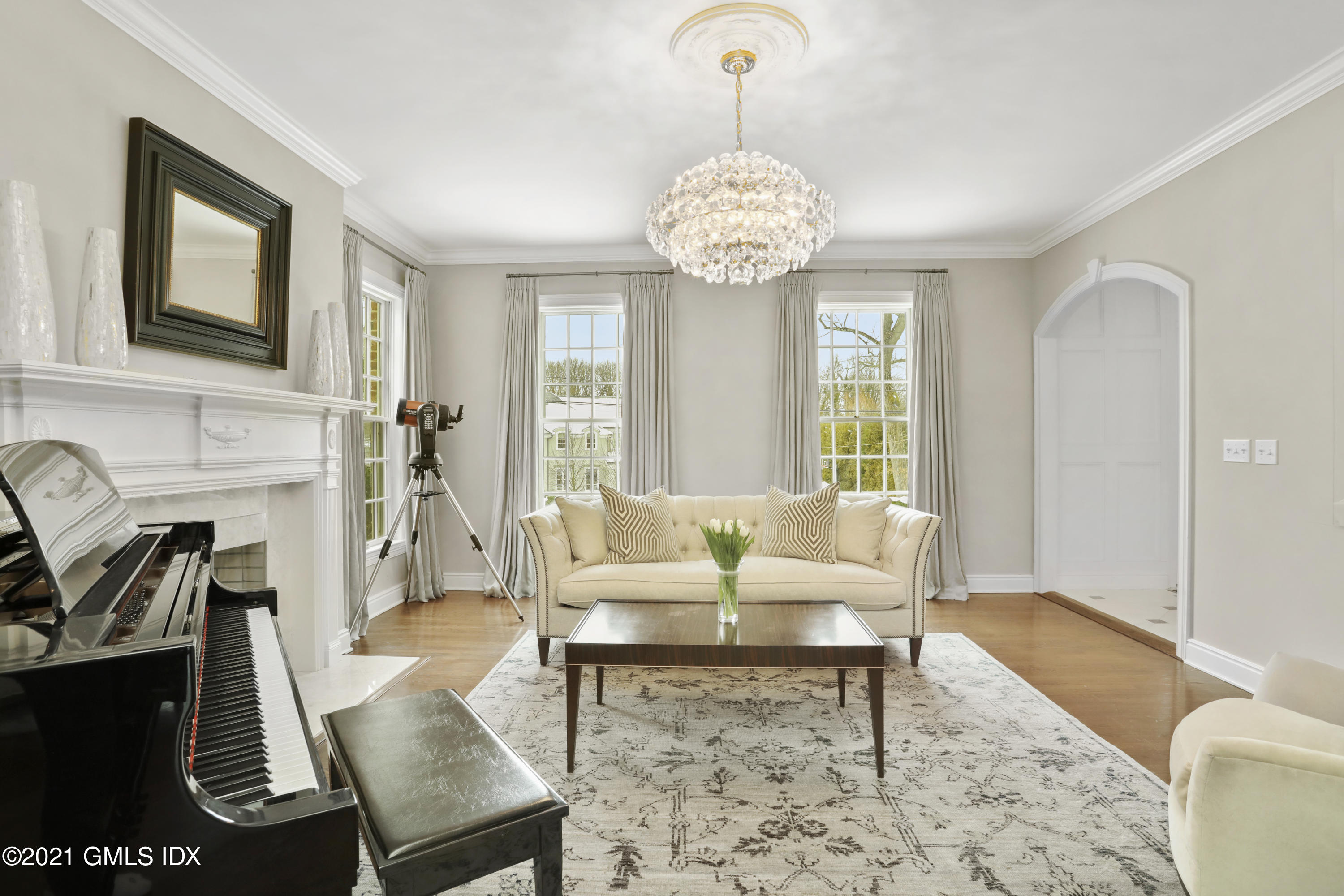 41 Dawn Harbor Lane Riverside, CT 06878 - Photo 10 of 33 a living room with furniture a chandelier and a fireplace